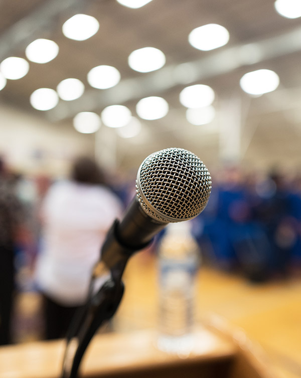 Closeup of microphone on an auditorium podium.