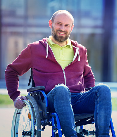 happy smiling man sitting on wheelchair in the medical center