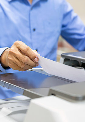 Businessmen Put the papers on the copier for copy and scanning documents papers in Office workplace.