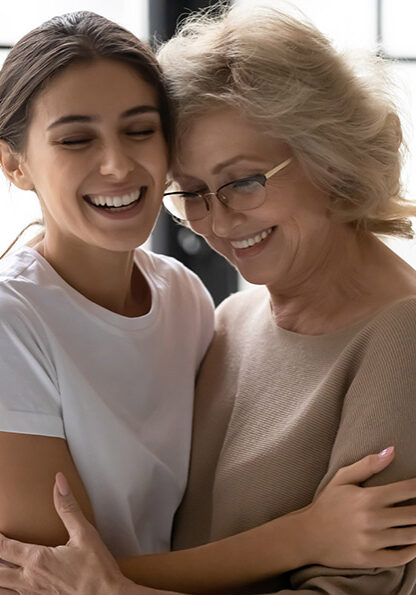 Overjoyed mature mother and adult daughter cuddle hug enjoying close tender moment together, happy senior mom and grown-up millennial girl child embrace showing support and understanding in family